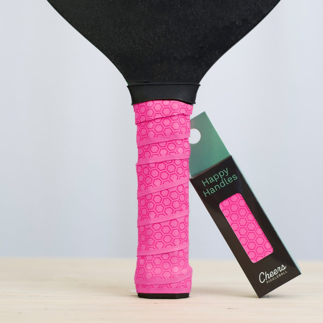 Happy Handles Hot Pink with with hexagon textured design displayed on a paddle