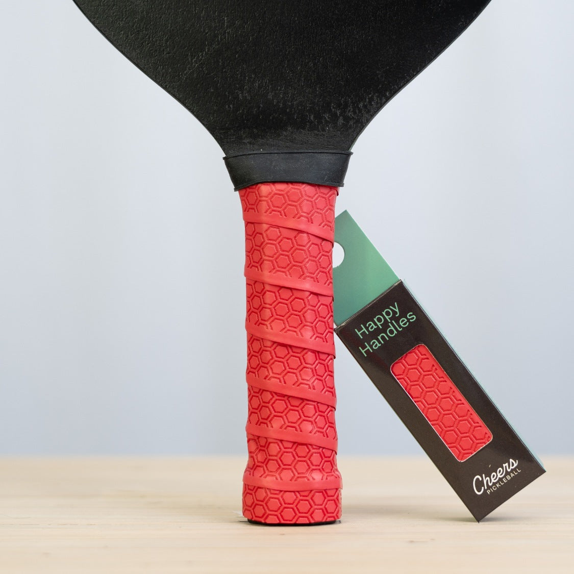 Happy Handles Radiant Red with with hexagon textured design displayed on a paddle