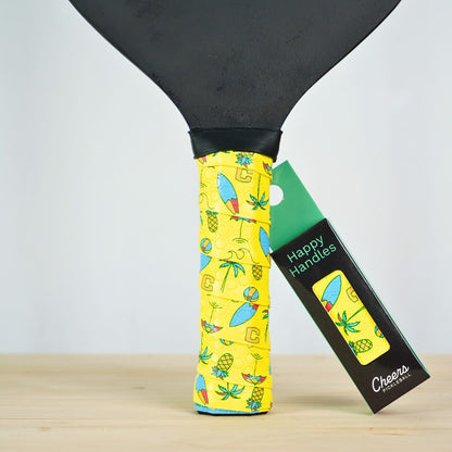 Happy Handles Beach Vibes Pickleball Grip in vibrant yellow with tropical designs, displayed on a paddle