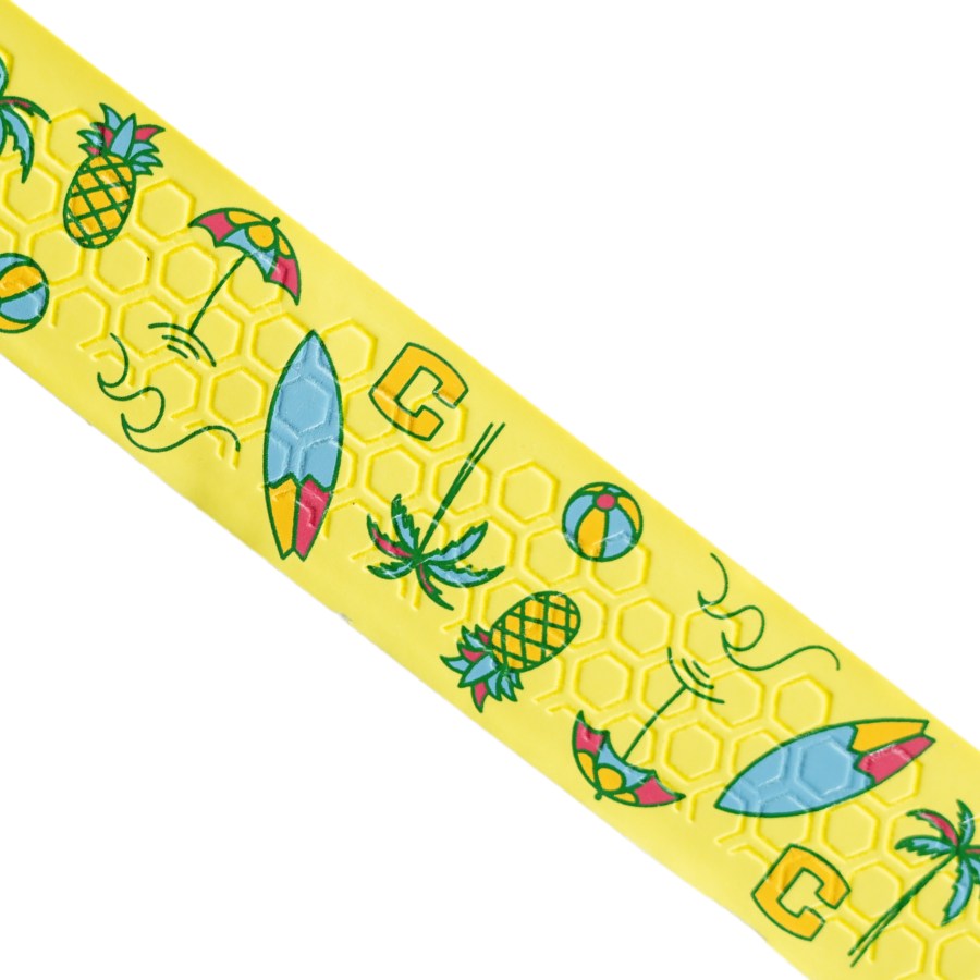 Close-up of Happy Handles Beach Vibes Pickleball Grip featuring tropical icons like pineapples, palm trees, and surfboards on a yellow background