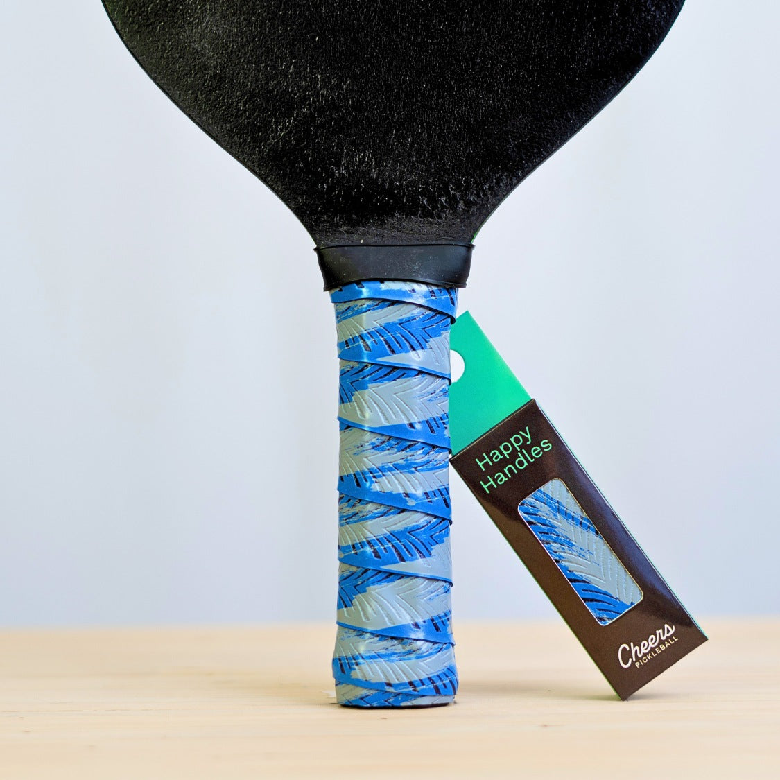 Happy Handles Brushed Blue Pickleball Grip in light blue brushed design, displayed on a paddle