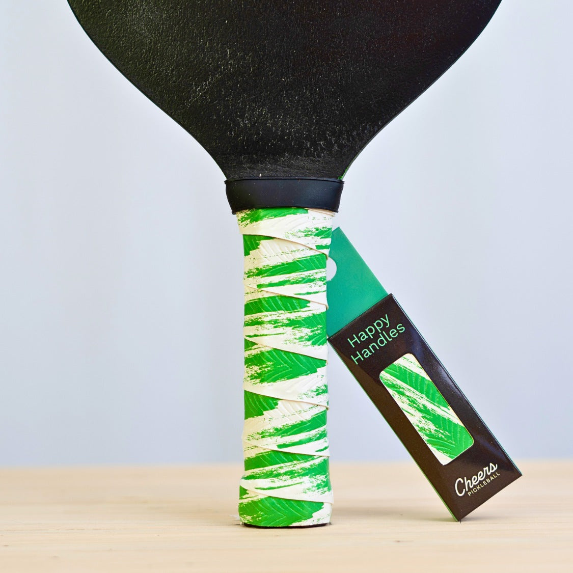 Happy Handles Brushed Green Pickleball Grip in green brush mark through white, displayed on a paddle