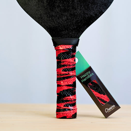 Happy Handles Brushed Red Pickleball Grip in black brush mark through red, displayed on a paddle