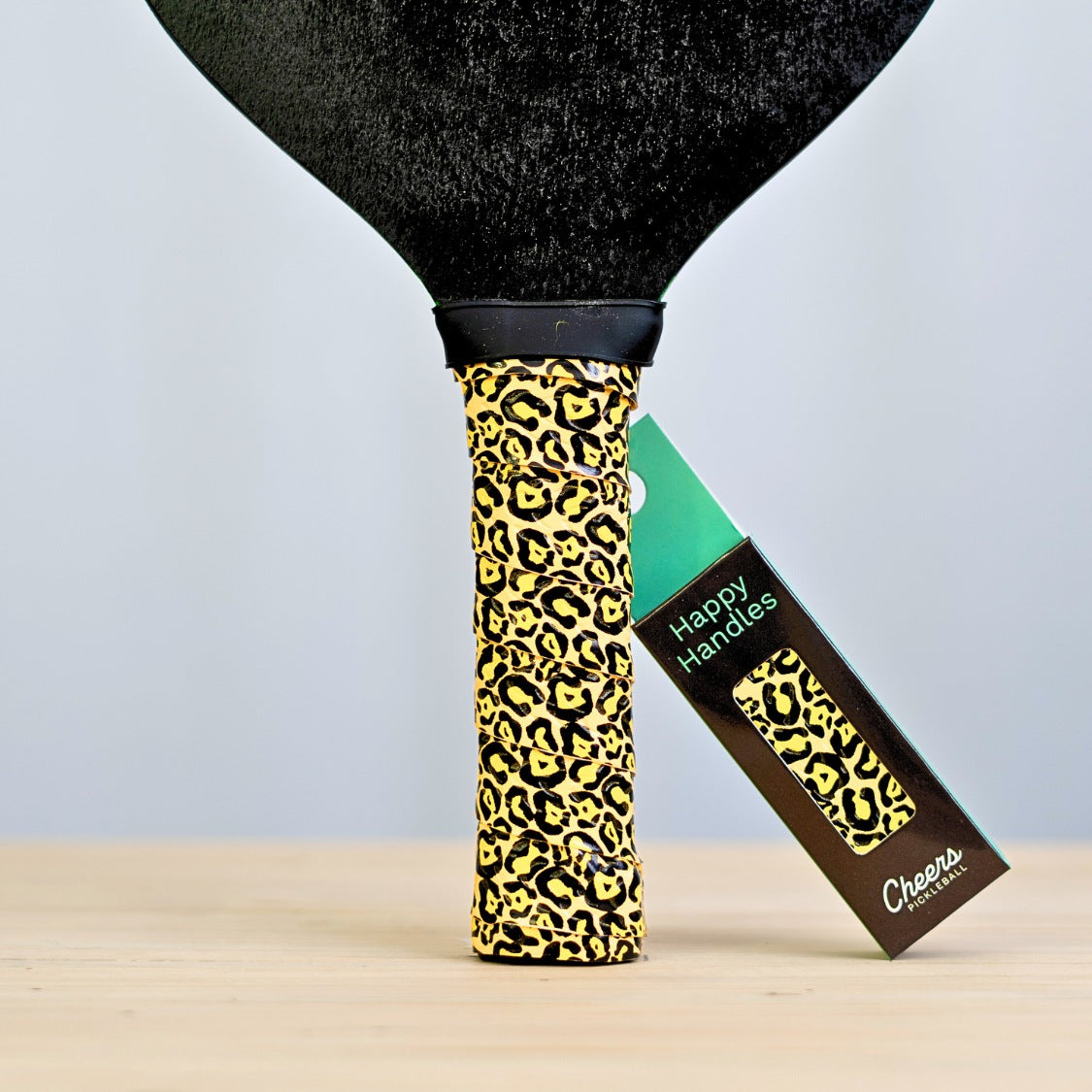 Happy Handles Leopard Pickleball Grip with leopard skin print displayed on a paddle