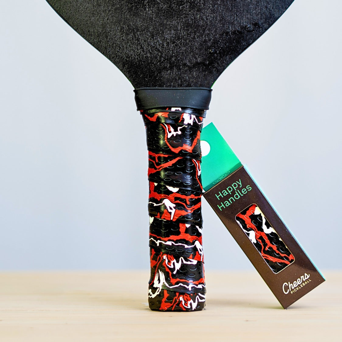 Happy Handles Paint Swirl, Black Grip with with red and white paint swirl design displayed on a paddle