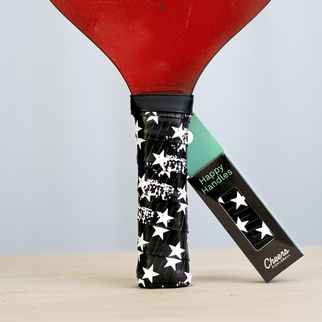 Happy Handles U-S-A with white stars from american flag displayed on a paddle