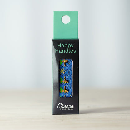 Happy Handles Hula Hula Pickleball Grip in its packaging, featuring hula girls and hibiscus flower, visible through the product box window